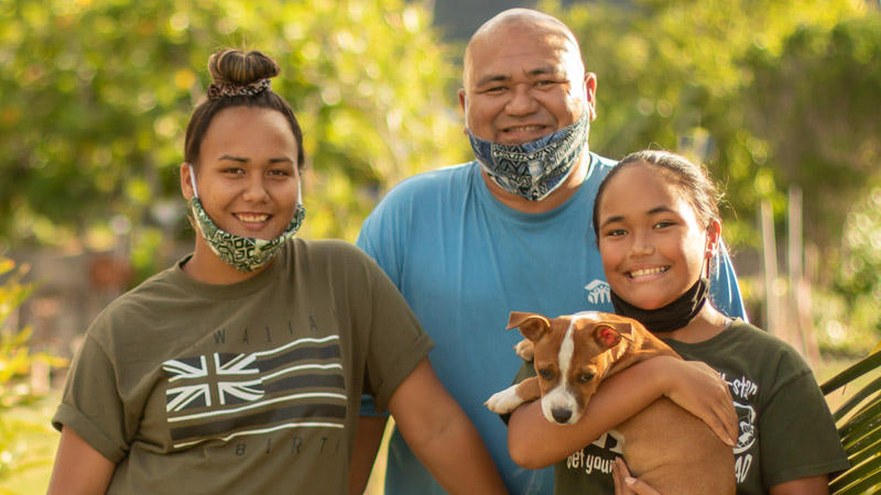 Outdoor photo of family with their dog